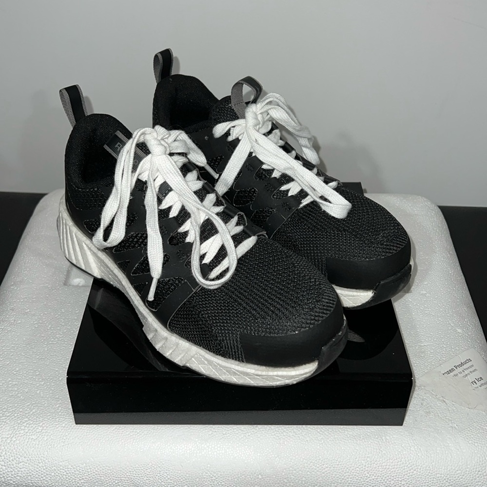 Women’s athletic rubber sole, slip resistant black and white work shoe.